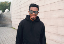 Portrait Happy Young Smiling African Man Wearing Black Hoodie, Sunglasses On City Street