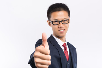 Portrait of a happy businessman in eyeglasses pointing finger away over white background