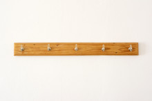 Simple Vintage Clothes Hanger With Hooks For Clothes On A White Wall