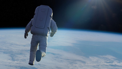 Canvas Print - astronaut performing a spacewalk in orbit of the beautiful planet earth