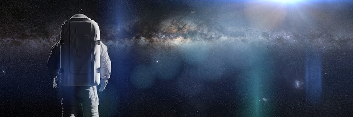 Canvas Print - standing astronaut in front of the beautiful milky way galaxy