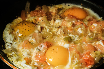 the fresh eggs and potatoes are fried in a pan