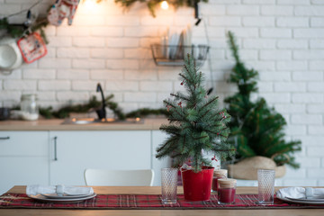 Christmas decoration of the kitchen of the house in the loft style. Decorations with fir branches and garlands