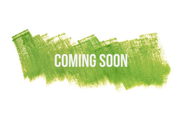 Coming soon on green paint background, isolated on white. Advertising banner concept.