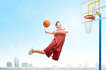 Poster - Asian basketball player man jumps in the air with the ball trying to score