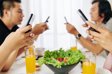 Poster - Family members texting and checking social media on smartphones instead of talking at breakfast