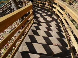 Wall Mural - Wide shot of concrete stairs with the sun casting shadows on the steps