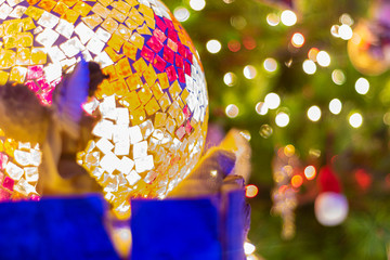 Decorated Christmas tree and creche on a blurred background, and you can see the lights and the warm colors which give it a true spirit and mood