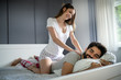 © NDABCREATIVITY - Cheerful young couple making massage at home