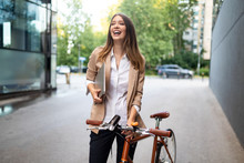Business Woman With Bicycle To Work On Urban Street In City. Transport And Healthy Lifestyle Concept