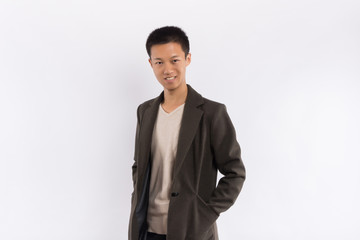 Handsome Asian male wearing a coat in front of white background