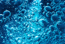 Sparkling Mineral Water Background. Blue Bubbles Of Fresh Soda Float To The Surface Of Drink To Quench Your Thirst