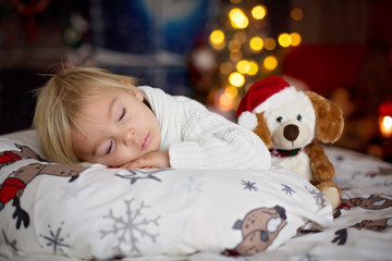 Sticker - Sweet beautiful blond toddler boy, sleeping in bed with toy