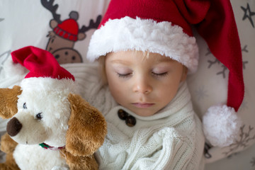 Poster - Sweet beautiful blond toddler boy, sleeping in bed with toy