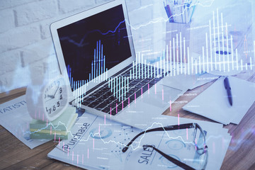 Financial market graph hologram and personal computer on background. Double exposure. Concept of forex.