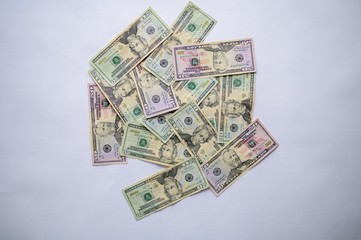 Wall Mural - Overhead shot of dollar bills on a white surface