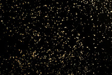 Christmas Gold Glitter On Black Background. Holiday Abstract Texture
