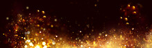 Golden Christmas And New Year Glittering Stars Swirl On Black Bokeh Background, Backdrop With Sparkling Golden Stars, Holiday Garland, Magic Glowing Dust, Lights. Gold Abstract Glitter Blinking Sparks