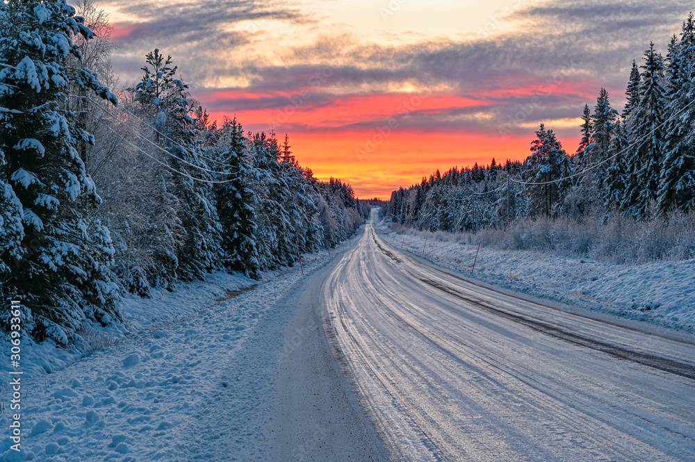 winter road in Varmland Sweden and orange sunrise - obrazy, fototapety, plakaty 