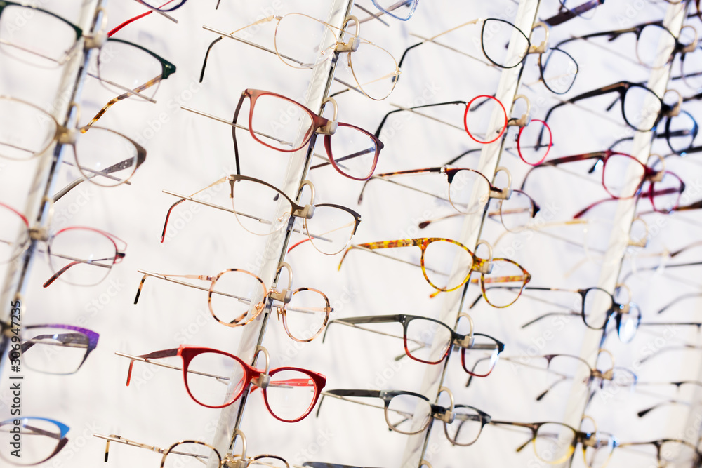 Glasses showcase in modern optic shop - obrazy, fototapety, plakaty 