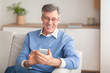 © Prostock-studio - Positive Senior Gentleman Using Phone Sitting On Couch At Home