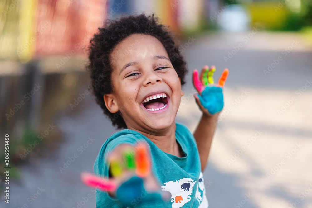 beautiful happy boy with painted hands - obrazy, fototapety, plakaty 