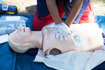 Wall Mural - First aid and CPR training using automated external defibrillator device - AED