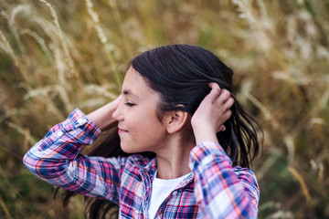 Poster - A school child standing on field trip in nature, headshot. Copy space.