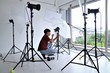 © Nawat - Photographer working with equipment lighting system camera portrait professional studio set up position
