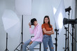 Couple model with camera in photograph studio background