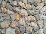 Fototapeta Desenie - Interesting and natural looking wall facade made of stone rocks as bricks for rough texture and natural exterior look design
