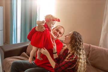 Happy family in the apartment playing together at home.