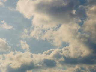 Blue sky with sunny white grey clouds.