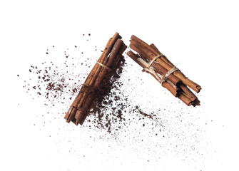 Sticker - Cinnamon sticks with powder splash or explosion flying in the air isolated on white background