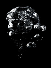 Air bubbles in the water on black background.