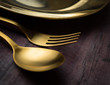 © showcake - Brass Spoon, fork and plate on wood table