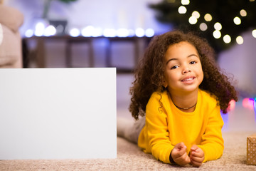 Cute friendly afro little girl resting near awesome Christmas offer