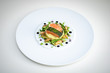 Salmon with Dill  and Sauteed Vegetables served on white plate over white texture background. Top view, copy space. Plating, fine dining