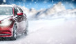 Car in winter on snowy road. Speed snow cars background with mountains.