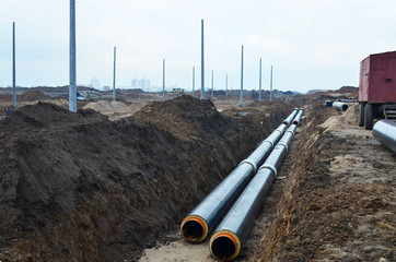 Laying underground storm sewers at a construction site. Groundwater system for new residential buildings in the city. Installation of water main, sanitary sewer, storm drain systems in city.