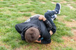 © Олег Копьёв - Children fight. Conflict of teens on the playground. The guys are lying on the ground. Peers grappled in a fight. The child strikes a friend. Children did not share toys among themselves.