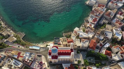 Wall Mural - Aerial drone video of picturesque district built by the sea of Vaporia in main town of Syros or Siros island Ermoupolis and famous church of Agios Nikolaos, Cyclades, Greece