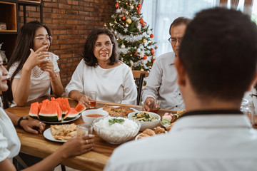 Wall Mural - happy asian family tradition having lunch together on christmas day at home