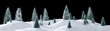 Wintry forest scene of miniature snow covered trees on glittering snow drifts isolated on black