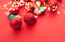 Some Christmas Balls On Red Background With Bokeh, Selected Focus.