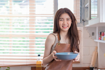 Asian woman chef cook or housewife preparing food in kitchen, Cooking and preparing food meal concept