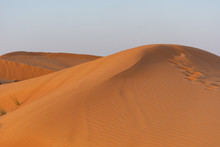 Desert At Sunrise Brings Out Bold Burnt Orange Colored Sand Making A Great Desert Landscape On Rippling Or Rolling Hills In Ras Al Khaimah, In The United Arab Emirates.