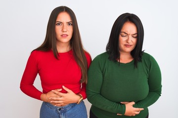 Sticker - Young beautiful women wearing casual clothes standing over isolated white background with hand on stomach because indigestion, painful illness feeling unwell. Ache concept.