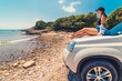© phpetrunina14 - woman laying at car hood with view of sea summer beach