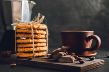 Homemade Cookies And Brown Cup With Coffee On Dark Background